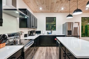 Culinary adventures await in this sleek, modern kitchen with stylish accents and ample space!
