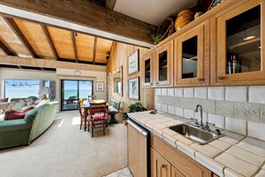 Enjoy a built-in wet bar with a sink, mini-fridge, and glassware for wine or cocktails.