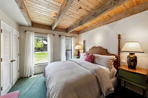 The primary bedroom features a king bed, private ensuite bathroom, and serene ground-floor location for added privacy and comfort.