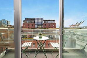 Relax on the private balcony with views of Puget Sound & Pioneer Square