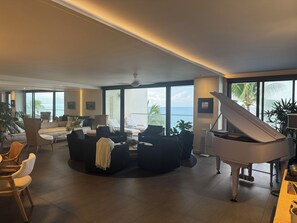 Living Area w/ 6 Swivel Arm Chairs, a low coffee table. 14' Punee (day bed)...
