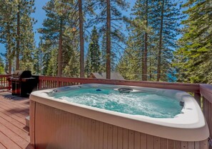 Private hot-tub with lakeviews on large deck with BBQ, dining table, outdoor furniture and more.