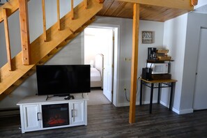 Living Room TV, Coffee Bar and Microwave and Entrance to Main Bedroom