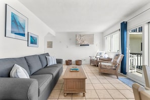 Enjoy the spacious living room with a comfy sleeper sofa and a breathtaking view.