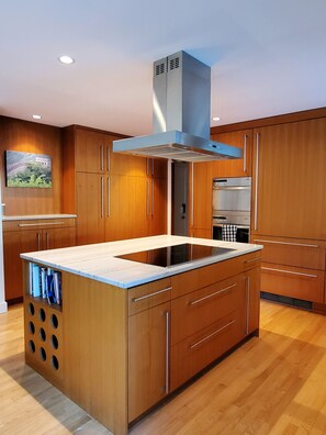 Kitchen with induction cooktop, wall oven, and microwave.