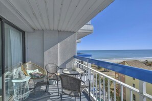 Sit outside and relax on this ocean view balcony and listen to the waves.