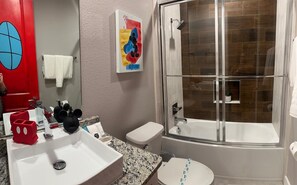 Modern full bathroom is attached to Mickey's Clubhouse room.