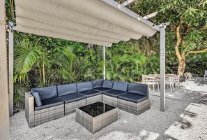 Fire up the grill and enjoy a backyard built for unforgettable gatherings! This lush outdoor space features a shaded lounge, dining area, and plenty of greenery, creating the perfect setting for cookouts