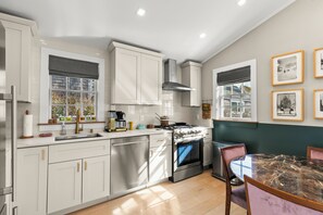 showcases top-tier stainless steel appliances and durable Dekton countertops