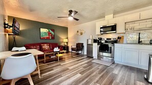 All-in-one comfort with a full kitchen, cozy seating, and inviting décor—ideal for couples or solo travelers.