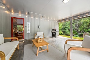Take in the fresh mountain air while lounging on this inviting patio, complete with stylish seating and a beautiful natural backdrop.