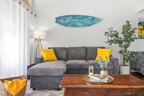Bright and Airy: The living room boasts vaulted ceilings and ample natural light, creating an open and welcoming space.