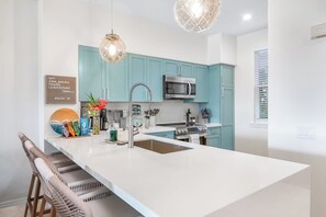 Ample counter space and a fully stocked pantry make the chef’s kitchen a dream for any cooking enthusiast.