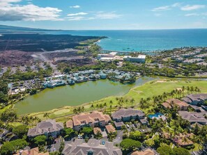 The unit opens up to lush green spaces with stunning golf course views, offering a serene backdrop right from the lanai.