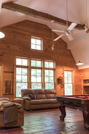 Game room with smart TV, pool table, books, board games, & giant Scrabble