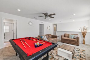 Challenge your crew in this fun filled game room with a pool table - Kick back on comfy sofas and enjoy a space designed for laughter and friendly competition - Perfect hangout for game nights, movie marathons, and making unforgettable memories