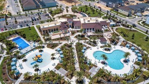 Solara Resort’s clubhouse with pools, waterslides, and tropical scenery.
