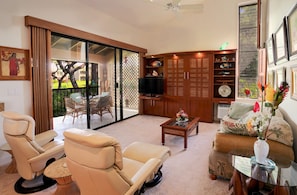 Living room with Murphy bed hidden behind beautiful custom wall unit