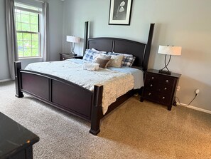 Spacious master bedroom featuring a plush king-size bed for ultimate comfort.