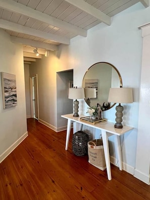 Hallway leading to guest suite, second bathroom and laundry
