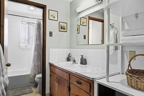 Bathroom stocked with towels, hand soap, and more for a comfortable stay.