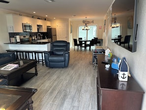 “Relax in comfort with leather seating and dual rocker recliners in this open living space.”