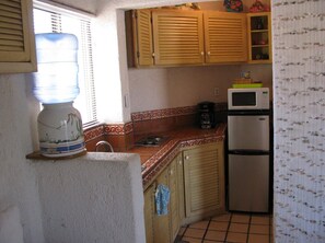 Condo has stove top, fridge, air fryer, various other kitchen gadgets.