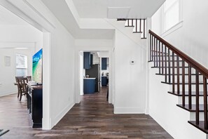 Kitchen is located down the entry hallway, living room is to the left and stairs leading up to the right.