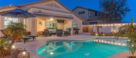 Stunning one story, 3 BR, 2 BA home with heated pool, putting green, 2 fire pits, covered patio with TV and 2 bikes.