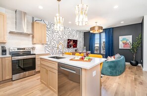 2nd Floor: Fully equipped kitchen with stainless steel appliances and a spacious island with seating for 3.