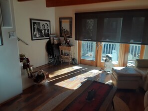 Living room with Dino, Sammy, and Frank pictured on the wall. Enjoying a laugh.