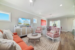Relax in our bright & bold living room with a 55” smart tv, & pullout couch bed.