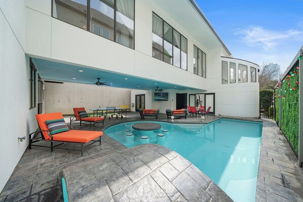 Private outdoor oasis w/a heated pool featuring a built-in table & stools. 