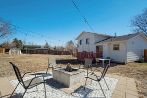 Gather around the fire pit for cozy evenings under the string lights in this spacious backyard retreat.




