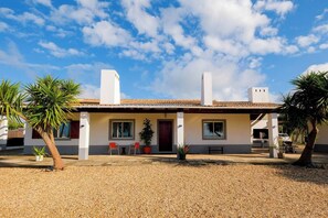 [House] Front of the house. The pool is just out of view to your left