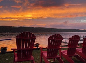Unwind in these cozy Adirondack chairs while the sky ignites with breathtaking sunset colors. Perfect for sipping wine and soaking in the peaceful lakefront vibes!