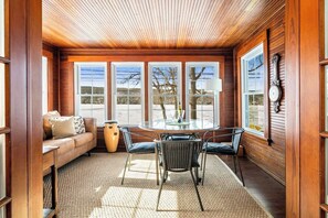 Rich wood tones, panoramic windows, and a chic dining setup make this an unbeatable spot for a meal or glass of wine overlooking the water.