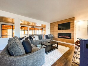 Spacious living area, great for entertaining, modern electric fireplace