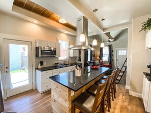 Open concept kitchen and living room with cedar accents stocked with everything needed for your stay.