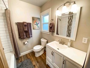 Bathroom is stocked with the essentials, like towels, toilet paper, shampoo and conditioner
