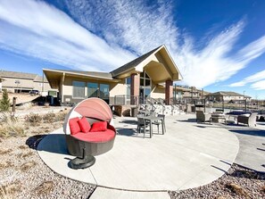 Clubhouse patio with gas grill, firepit, and lounge area