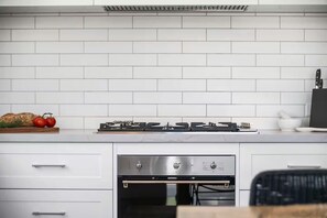 KITCHEN: Quality appliances are a feature with a 900mm cooktop, stone bench top and a pantry with many cooking basics for the chefs convenience.
