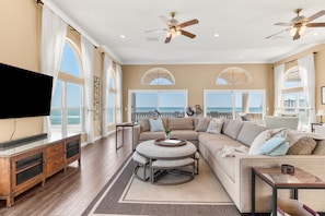 Second floor living room with multiple seating areas and panoramic ocean views. Comfortably seats up to 15- your entire group!