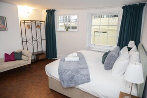 Master bedroom with comfortable double bed, crisp linens, and classic decor.