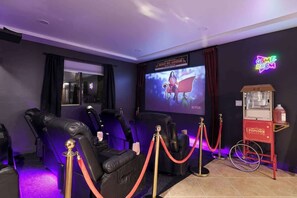 Movie nights redefined! Step into your private theater with plush seating, vibrant lighting, and a big-screen experience right at home.