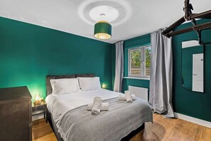 A private retreat designed for rest and rejuvenation. Soft lighting, a luxurious bed with premium linens, and thoughtfully selected furnishings create an atmosphere of effortless comfort. Expansive windows and lights complete this serene escape.