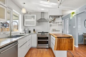 Full kitchen with south-facing windows, rice cooker & an insta pot with access to the backyard.