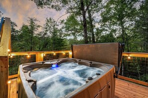 A second private back deck with hot tub and forest views.