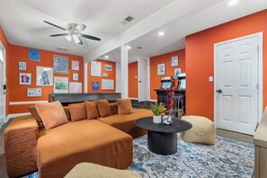 Game Room - with Arcade machines, a 3-in-1 Pool, Ping Pong, and dining table, a sectional and bench seating for everyone to enjoy