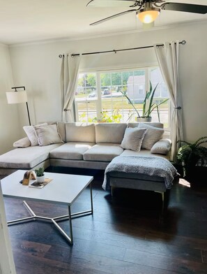 The living room is brightly lit and perfect for hanging out and relaxing.